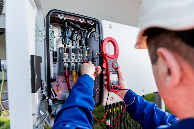 Engineer checking a fuse box